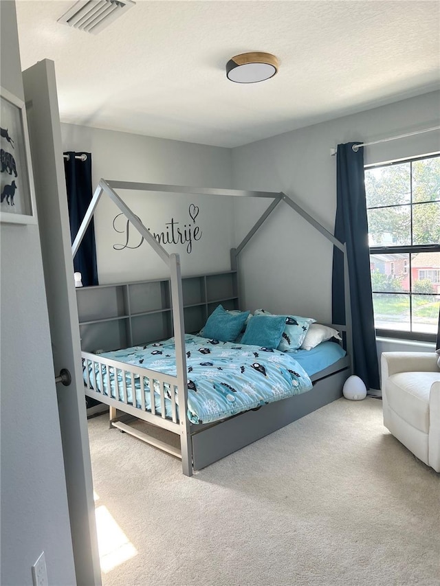 bedroom featuring carpet floors and visible vents