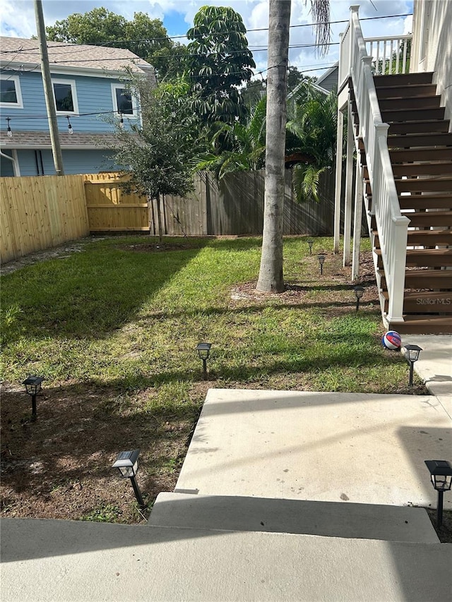 view of yard with stairway and fence