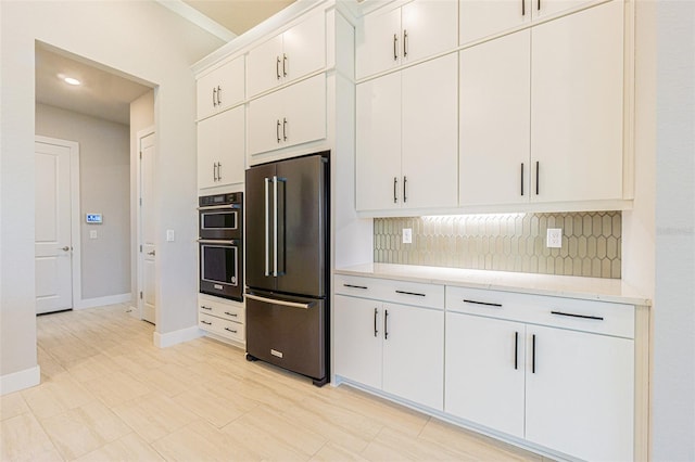 kitchen featuring white cabinets, backsplash, and stainless steel appliances