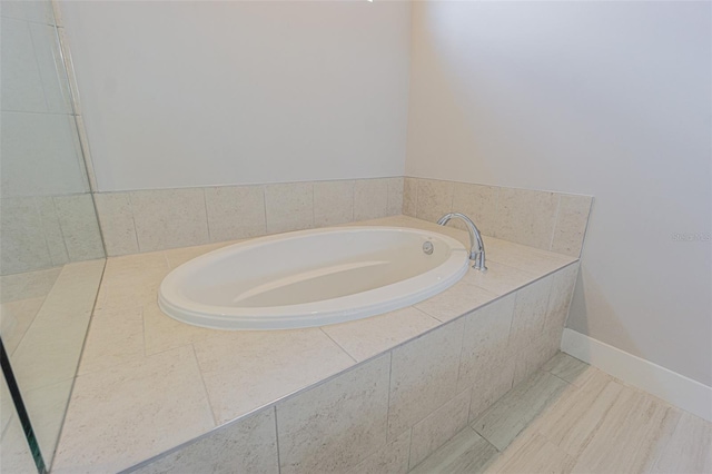 bathroom with tiled bath