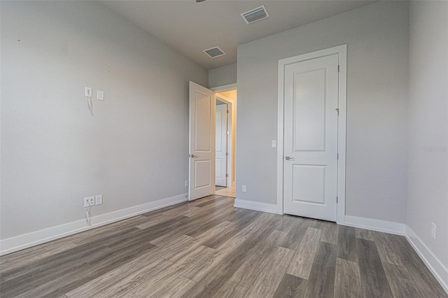 unfurnished bedroom with dark hardwood / wood-style floors