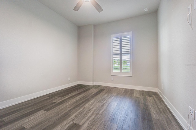 empty room with ceiling fan and dark wood-type flooring