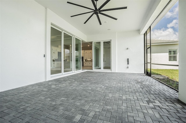 unfurnished sunroom featuring ceiling fan