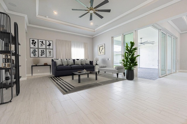 living room featuring a tray ceiling, ceiling fan, and ornamental molding