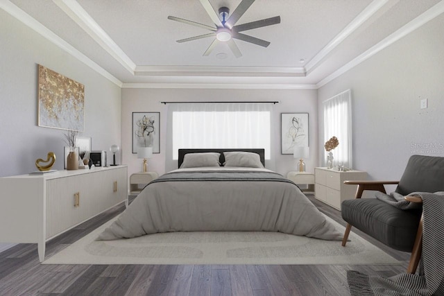 bedroom with hardwood / wood-style flooring, ceiling fan, ornamental molding, and a tray ceiling