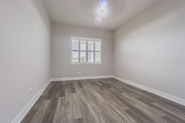 spare room featuring dark wood-type flooring