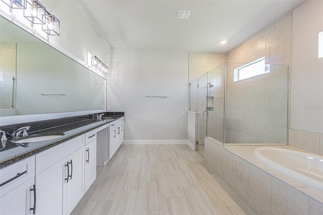 bathroom featuring separate shower and tub and vanity