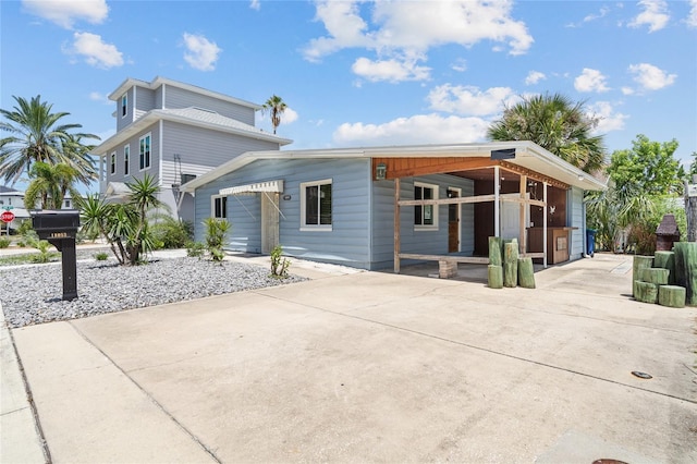 exterior space featuring a carport and driveway