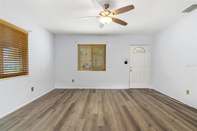 interior space featuring wood finished floors, visible vents, and a ceiling fan