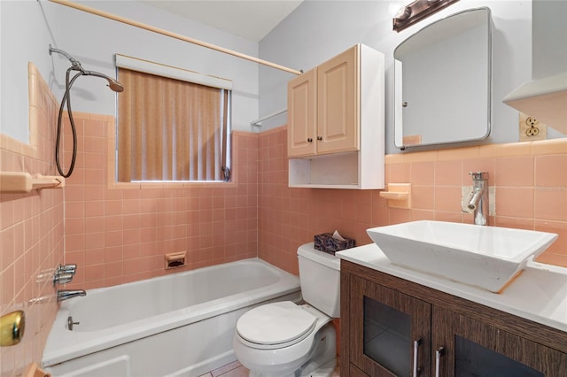 full bathroom with wainscoting, toilet, tub / shower combination, vanity, and tile walls