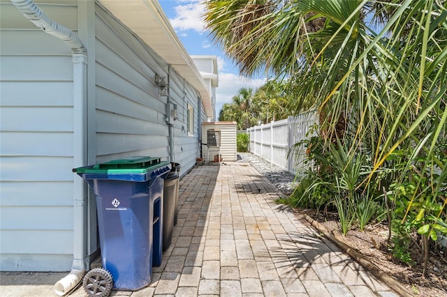 view of home's exterior with fence and a patio