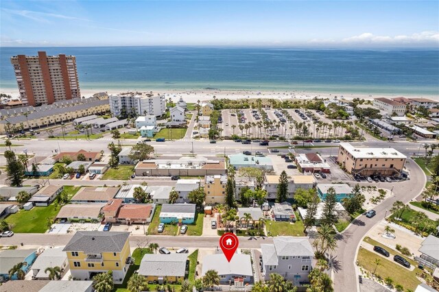 drone / aerial view featuring a beach view and a water view