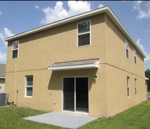 back of property featuring a patio and central air condition unit