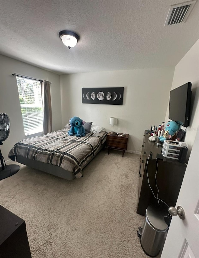 carpeted bedroom with a textured ceiling