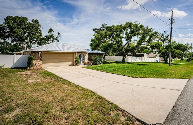 single story home featuring an attached garage, driveway, a front yard, and fence