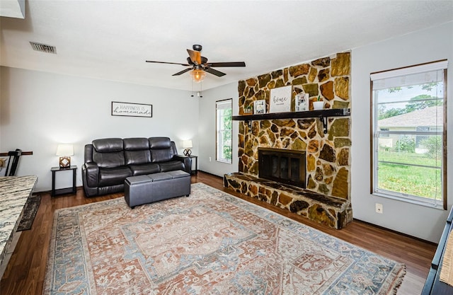 living room with ceiling fan, dark hardwood / wood-style flooring, and a fireplace