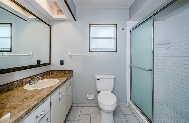 bathroom featuring a wealth of natural light, a shower stall, and vanity