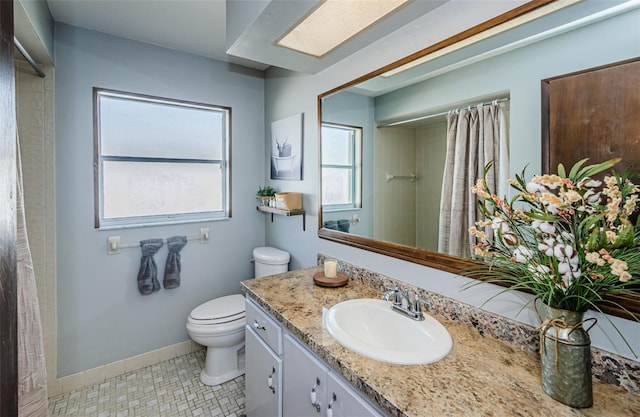 bathroom with tile patterned flooring, vanity, toilet, and curtained shower