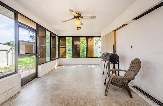 sunroom / solarium featuring ceiling fan and a healthy amount of sunlight