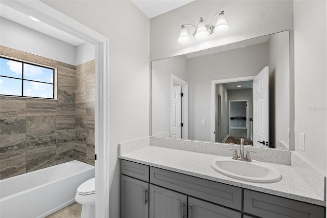 full bathroom featuring toilet, vanity, and tiled shower / bath