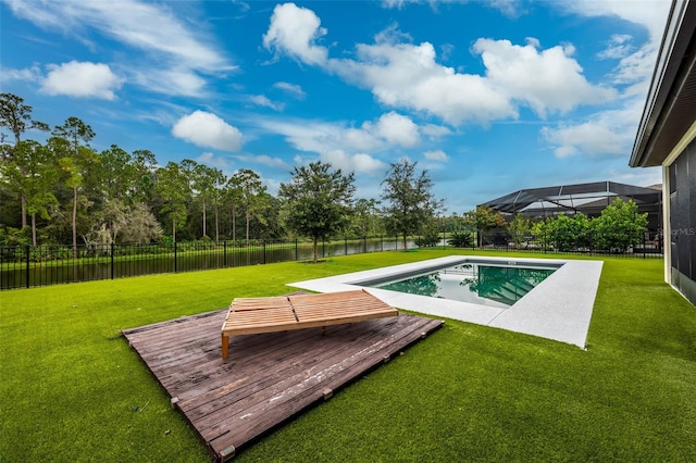 view of swimming pool with a deck with water view, a lanai, and a yard