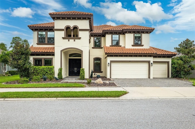 mediterranean / spanish-style house with a garage