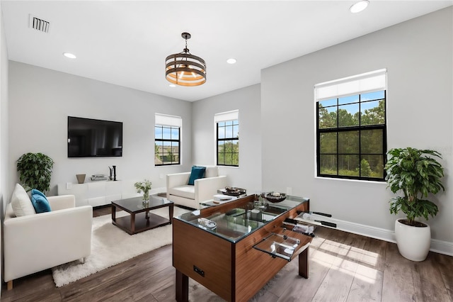 office space featuring dark wood-type flooring, an inviting chandelier, and plenty of natural light