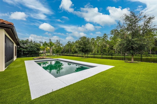 view of pool featuring a lawn