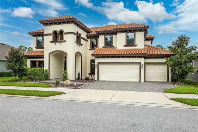 mediterranean / spanish-style house with a garage