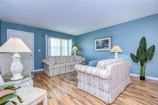 living room with a textured ceiling and wood-type flooring