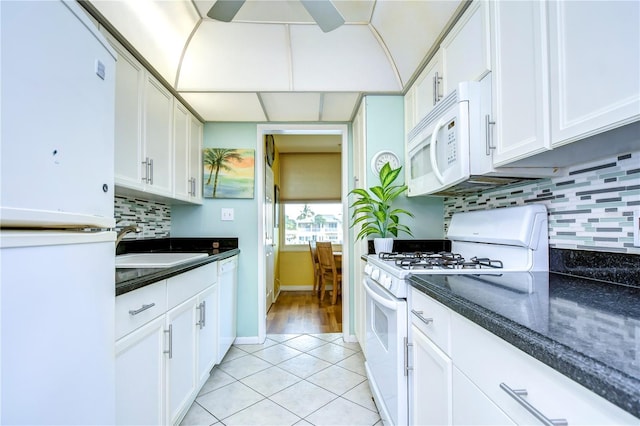 kitchen with white appliances, light hardwood / wood-style flooring, tasteful backsplash, white cabinetry, and ceiling fan