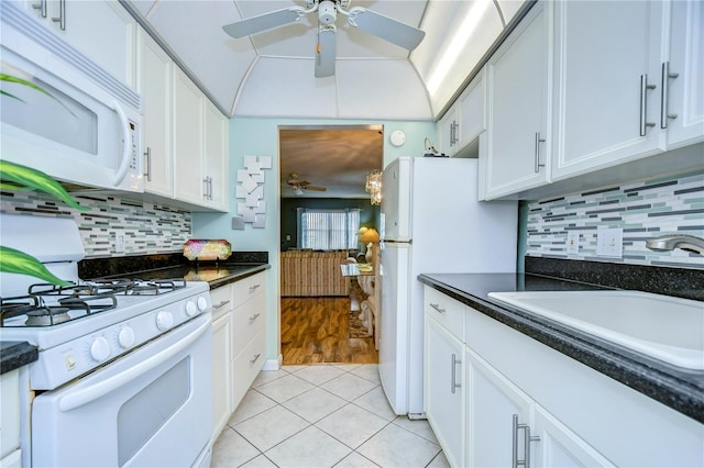 kitchen with white appliances, light hardwood / wood-style flooring, decorative backsplash, white cabinetry, and ceiling fan