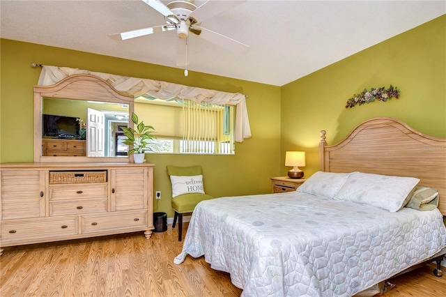 bedroom with ceiling fan and light hardwood / wood-style floors