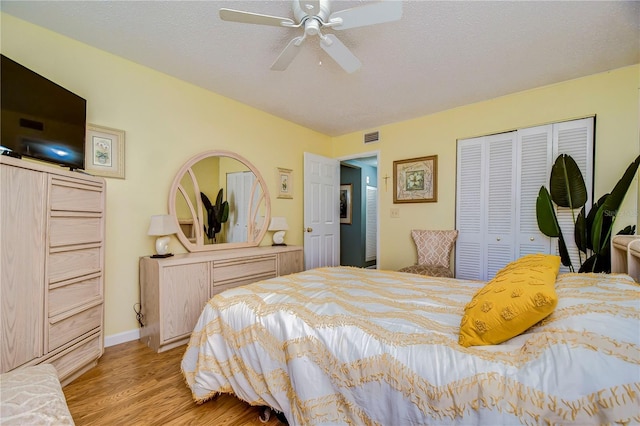 bedroom featuring ceiling fan, a closet, and light hardwood / wood-style floors