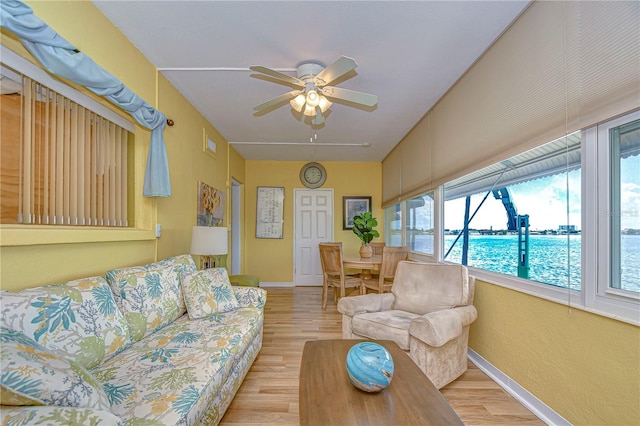 living room featuring ceiling fan and light hardwood / wood-style flooring