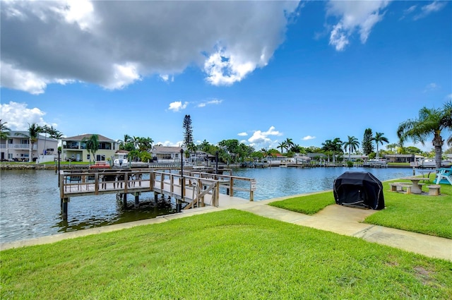 dock area featuring a yard and a water view