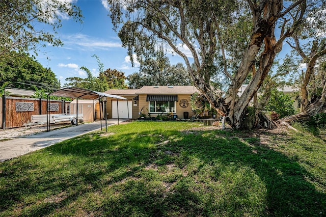 ranch-style house featuring a garage, a carport, and a front yard