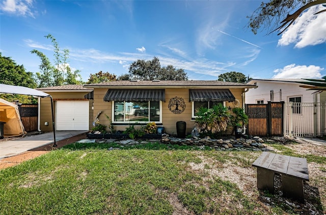 view of front facade with a front yard and a garage