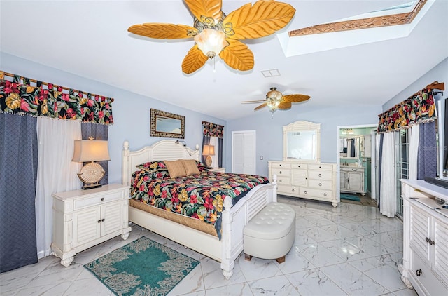 bedroom featuring light tile patterned floors, a skylight, ensuite bathroom, and ceiling fan