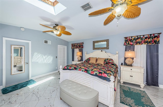 bedroom featuring a closet, ceiling fan, vaulted ceiling with skylight, and light tile patterned flooring