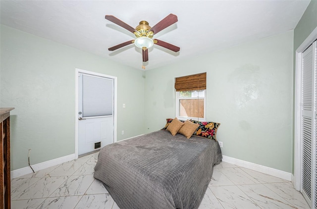 tiled bedroom featuring ceiling fan