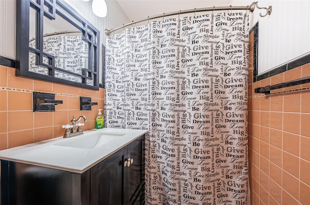 bathroom featuring tile walls, vanity, backsplash, and walk in shower