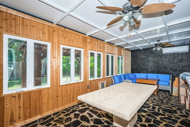 sunroom featuring a healthy amount of sunlight, coffered ceiling, and ceiling fan