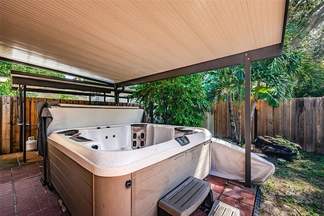 view of patio / terrace with a hot tub