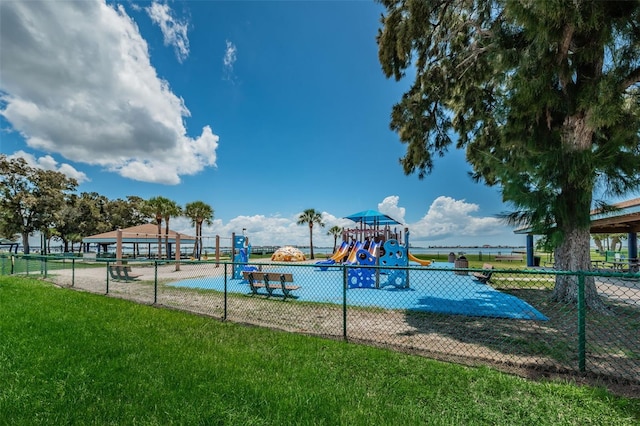 view of swimming pool featuring a yard and a playground