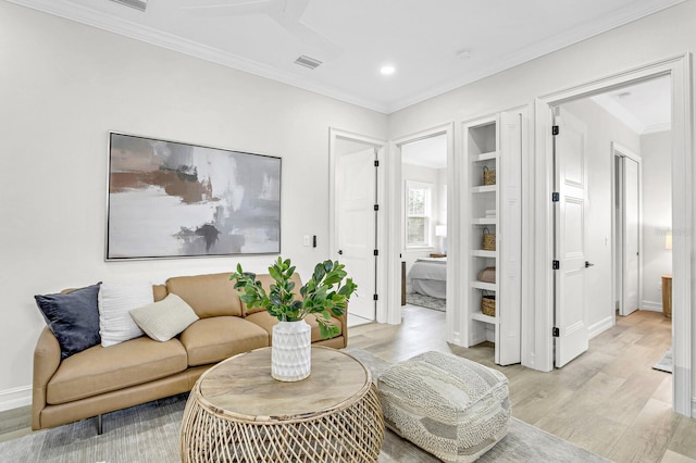 living room featuring crown molding and light hardwood / wood-style flooring