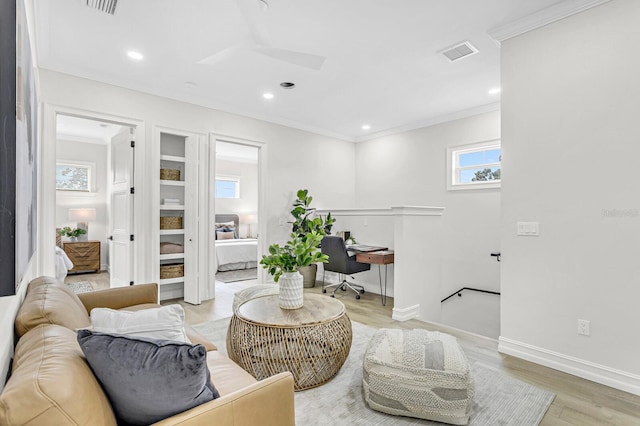 living room with crown molding, recessed lighting, visible vents, light wood-style flooring, and baseboards