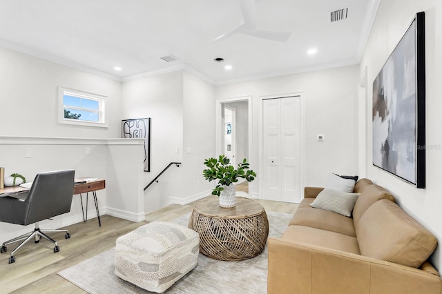 home office with crown molding and light hardwood / wood-style floors