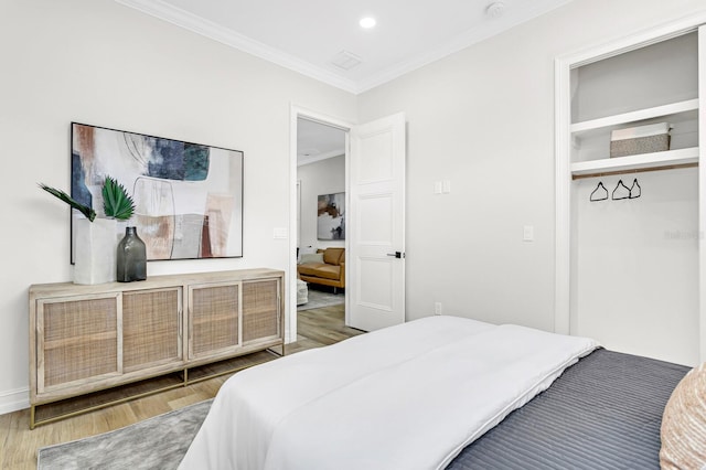 bedroom with crown molding and hardwood / wood-style flooring