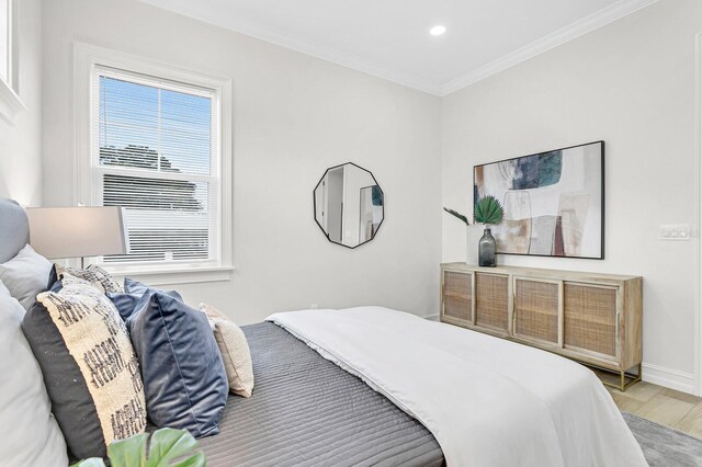 bedroom with crown molding and wood-type flooring